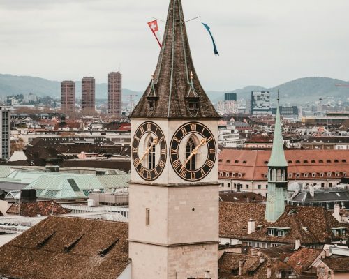 St. Peter Church in Zurich with its iconic clock tower, city skyline in the background